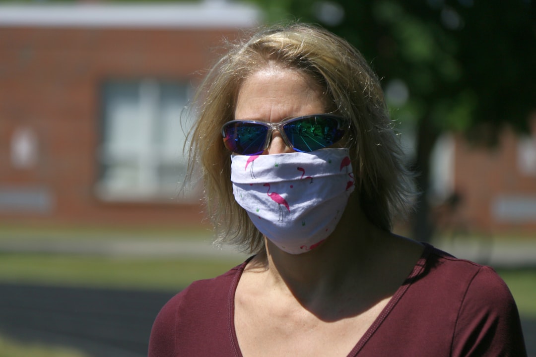 woman in red tank top with white mask