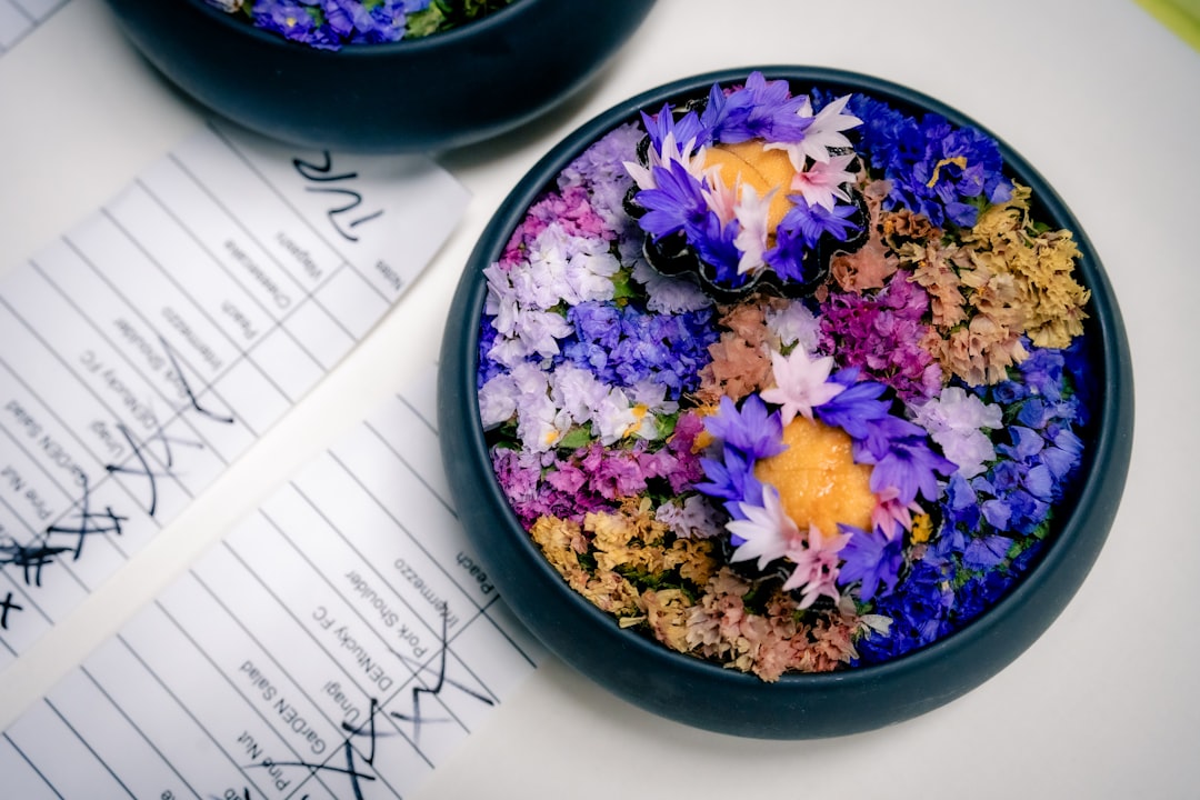 A couple of bowls filled with flowers on top of a table