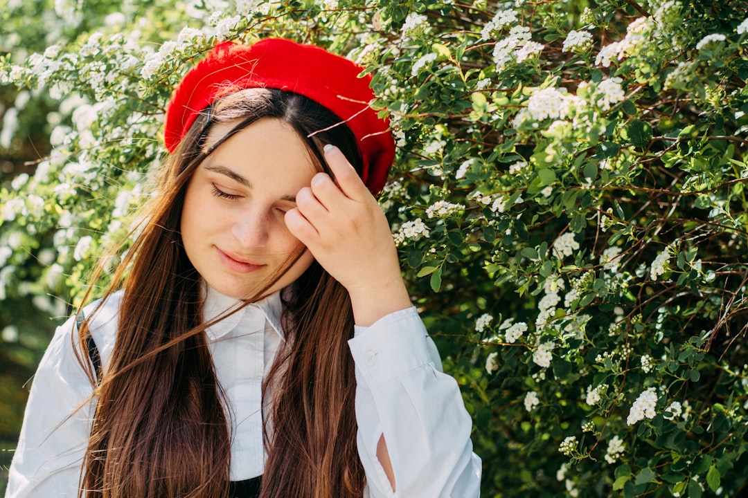 a woman wearing a red hat and a white shirt