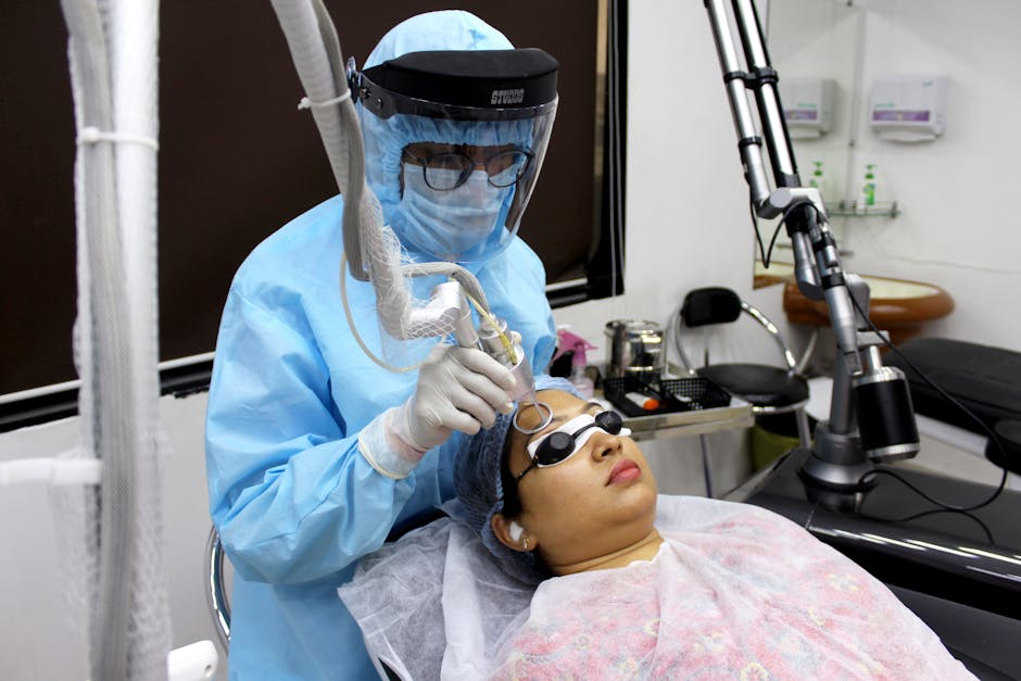 A medical practitioner performs laser treatment on a woman for skin care.