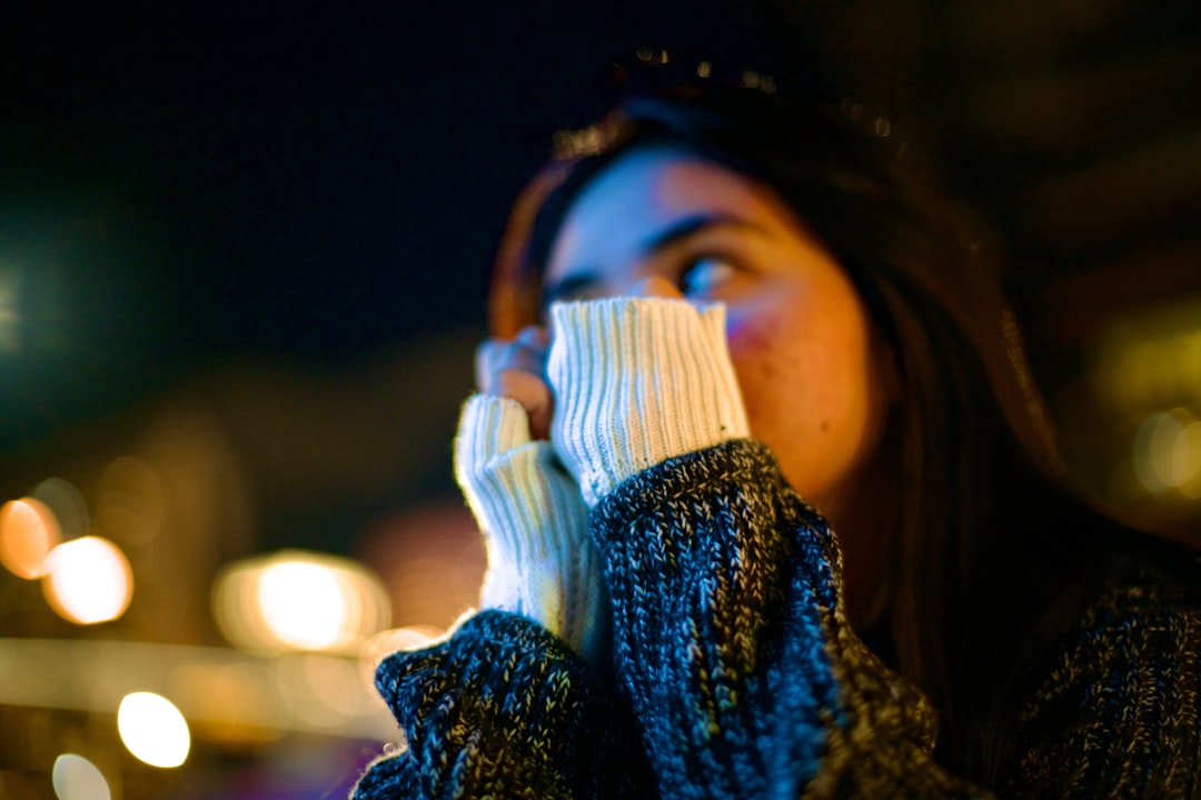 Woman holds her hands up while looking at something.