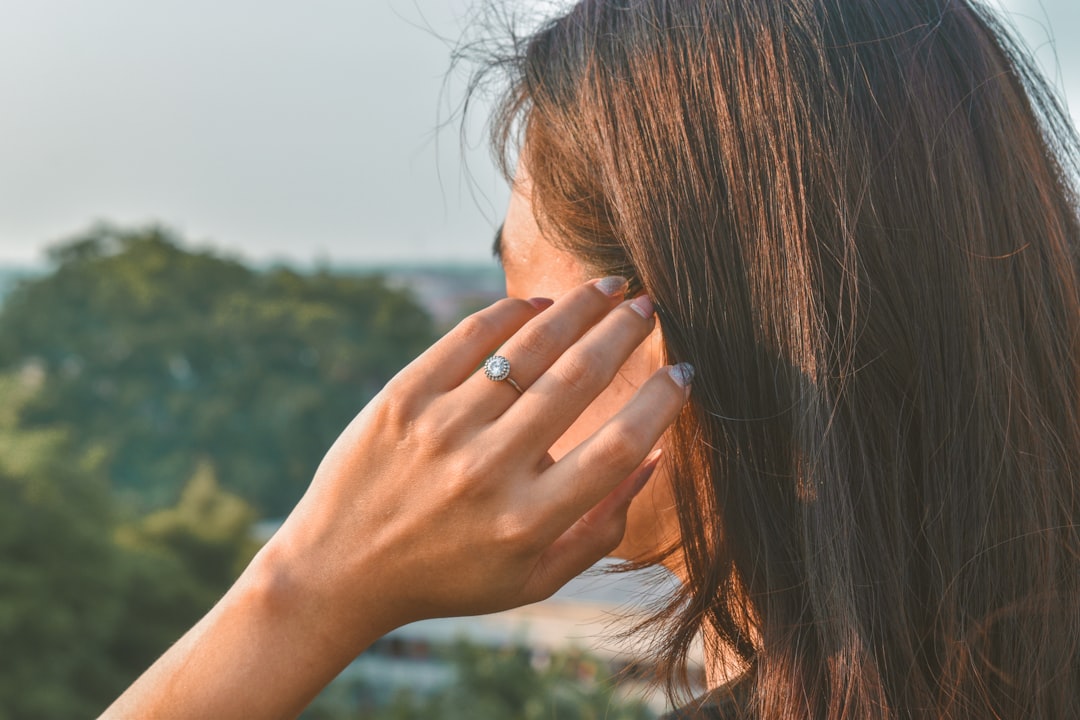 a woman holding her hand to her face