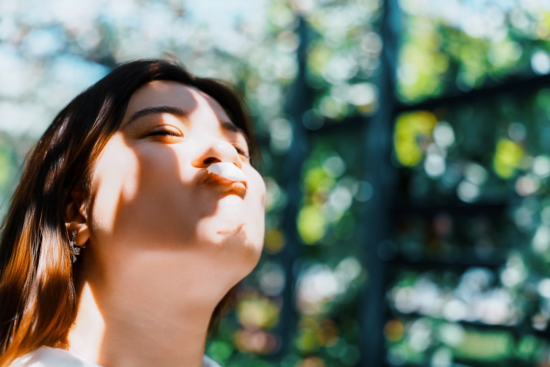 Woman with eyes closed and sun on her face