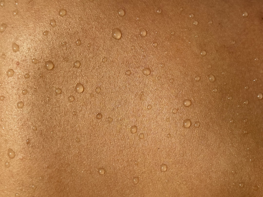 A man's back with water drops on it