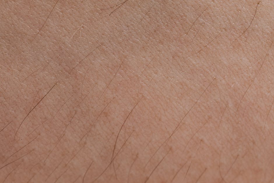 Detailed close-up of human skin texture and hair follicles.