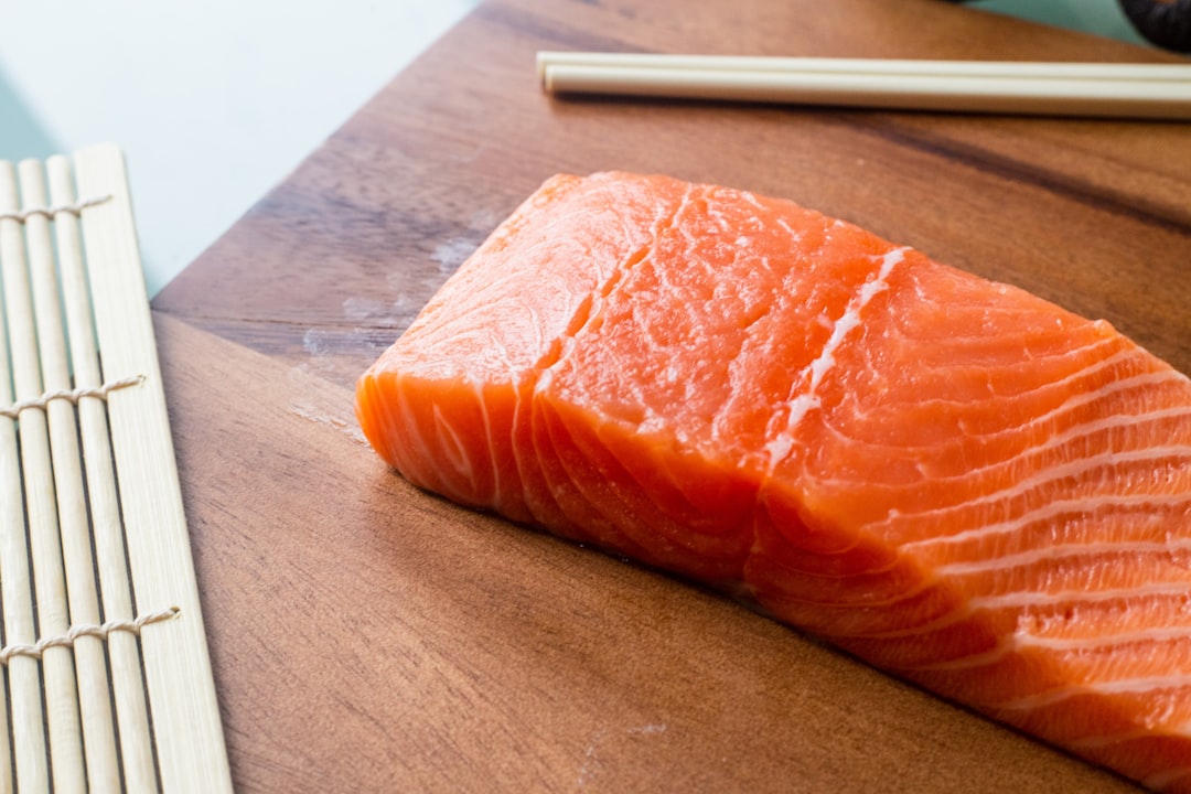 raw meat on brown wooden chopping board