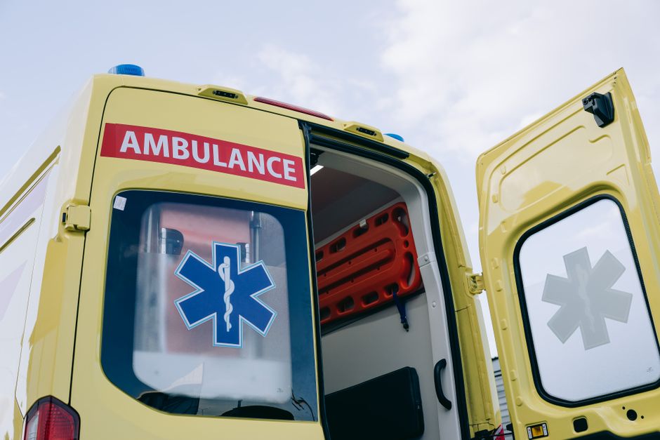 Yellow ambulance with open doors displaying medical interior equipment, emphasizing emergency response.