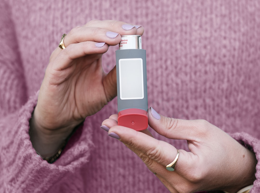 A woman holding a small electronic device in her hands