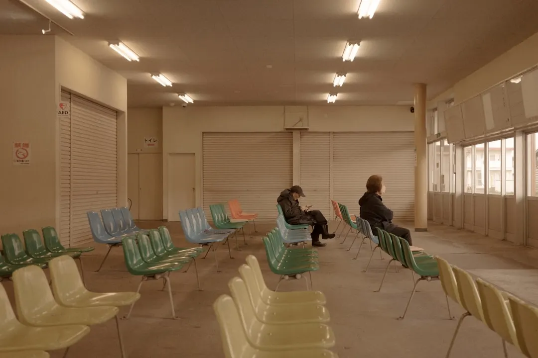 People sit in an empty waiting room